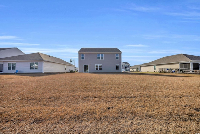 rear view of house with a yard