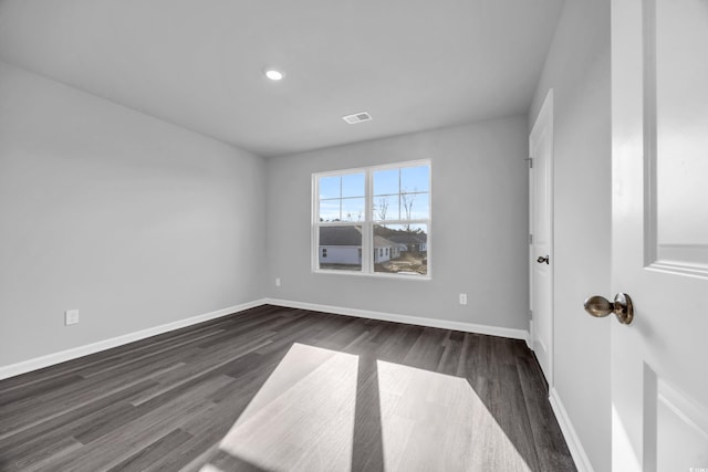 empty room with dark wood-type flooring