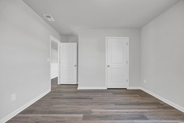 unfurnished room featuring dark hardwood / wood-style flooring