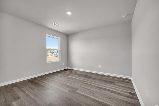 unfurnished room with hardwood / wood-style floors