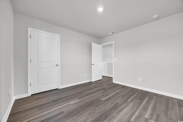 unfurnished bedroom featuring dark hardwood / wood-style flooring