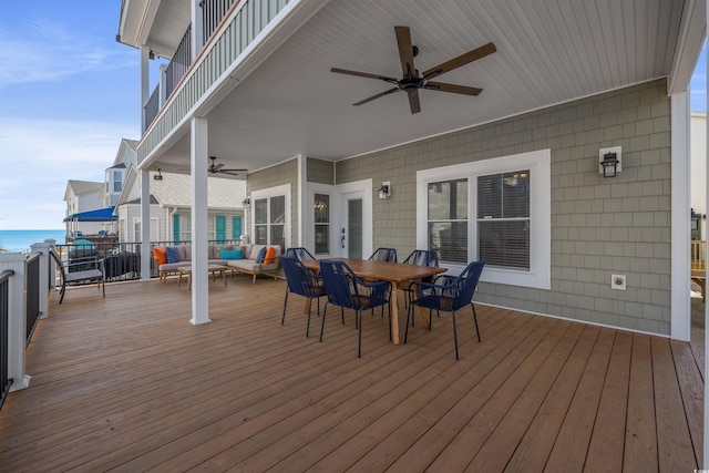 deck featuring an outdoor hangout area, a water view, and ceiling fan