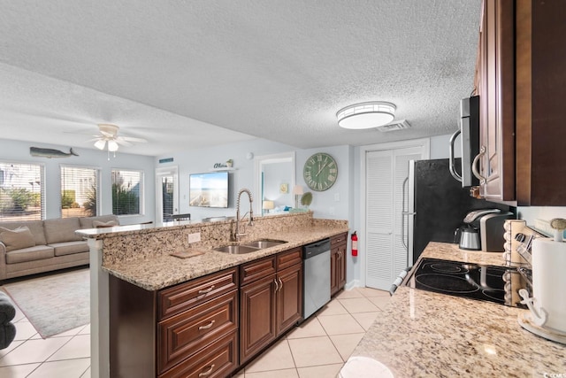 kitchen with light stone countertops, a textured ceiling, sink, dishwasher, and light tile patterned flooring