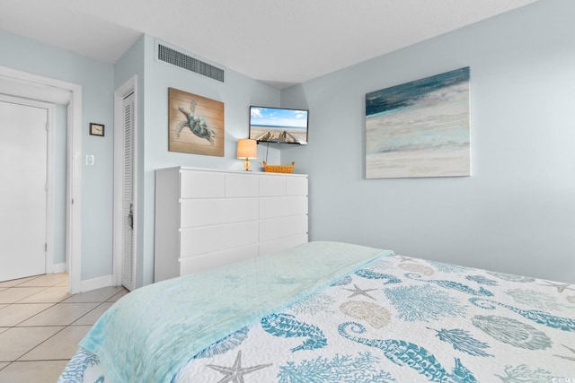 bedroom featuring light tile patterned floors and a closet