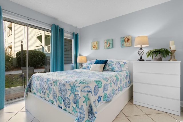 bedroom with access to exterior and light tile patterned floors