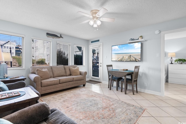 tiled living room featuring ceiling fan and a textured ceiling