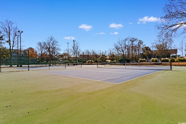 view of tennis court featuring basketball hoop