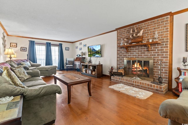 living room featuring a fireplace, hardwood / wood-style floors, a textured ceiling, and ornamental molding