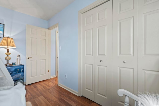 702 Plantation Dr, Surfside Beach, SC 29575 - bedroom with a closet, dark wood-type flooring, and baseboards