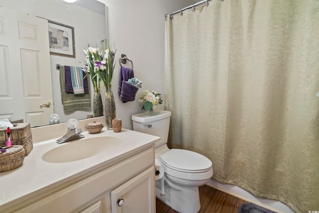 702 Plantation Dr, Surfside Beach, SC 29575 - bathroom with toilet, vanity, wood finished floors, and curtained shower