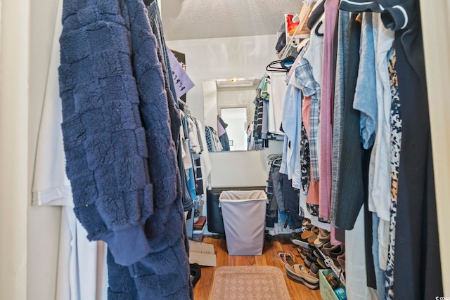 walk in closet with hardwood / wood-style floors