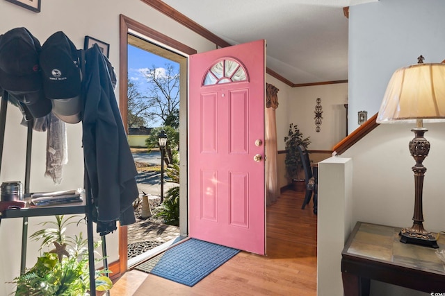 entryway featuring light hardwood / wood-style flooring and ornamental molding