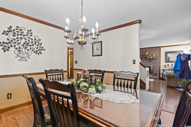 702 Plantation Dr, Surfside Beach, SC 29575 - dining room with crown molding, a chandelier, wood finished floors, and baseboards