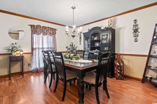 702 Plantation Dr, Surfside Beach, SC 29575 - dining area with wood finished floors, crown molding, a chandelier, and baseboards