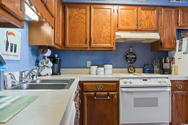 702 Plantation Dr, Surfside Beach, SC 29575 - kitchen featuring white electric range, under cabinet range hood, light countertops, and brown cabinetry