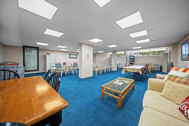 carpeted living room with a drop ceiling