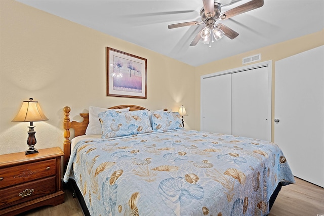 bedroom featuring ceiling fan, a closet, and light wood-type flooring