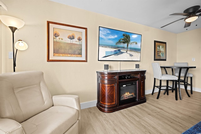 living area featuring ceiling fan and light wood-type flooring