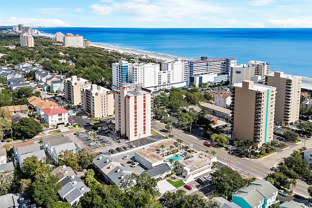 birds eye view of property with a beach view and a water view