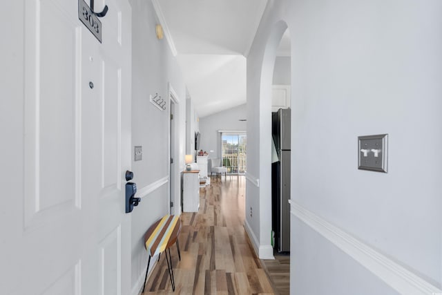 corridor featuring hardwood / wood-style floors and lofted ceiling