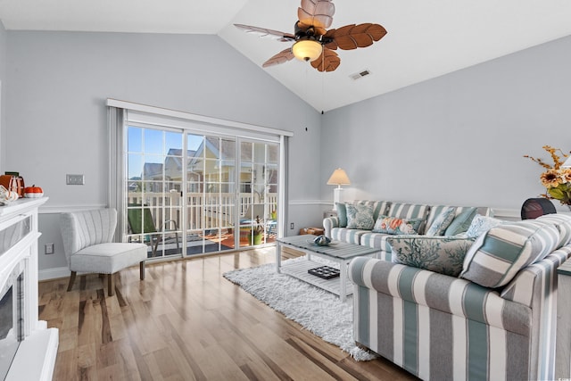 living room featuring hardwood / wood-style flooring, ceiling fan, and lofted ceiling