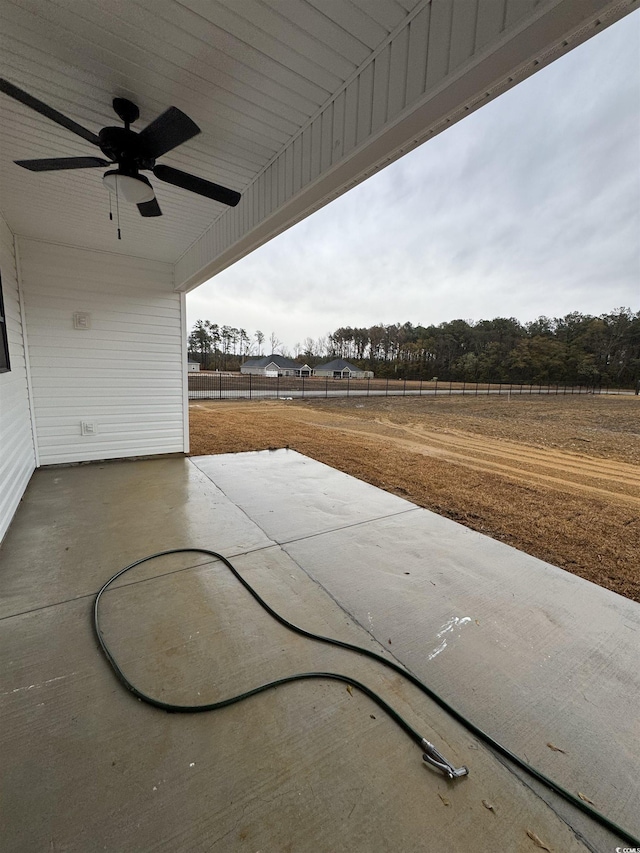 view of patio / terrace featuring ceiling fan and a rural view