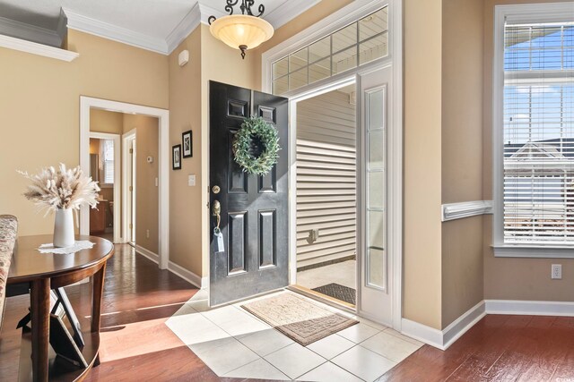 kitchen with white appliances, crown molding, sink, a wealth of natural light, and light tile patterned flooring