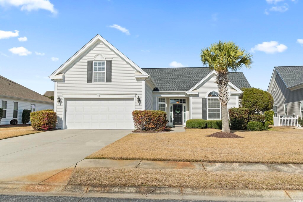 729 Woodcrest Way, Murrells Inlet, SC 29576 - traditional-style home featuring a garage, concrete driveway, and a shingled roof