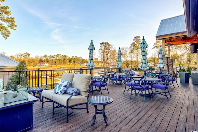 wooden terrace with an outdoor hangout area