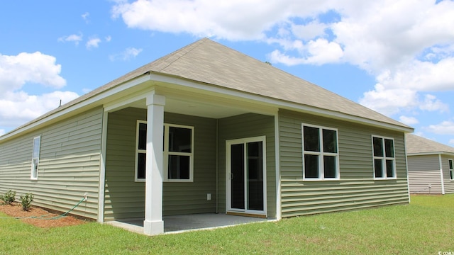 rear view of house with a lawn and a patio area