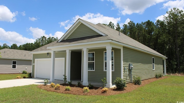 view of side of home with a yard and a garage