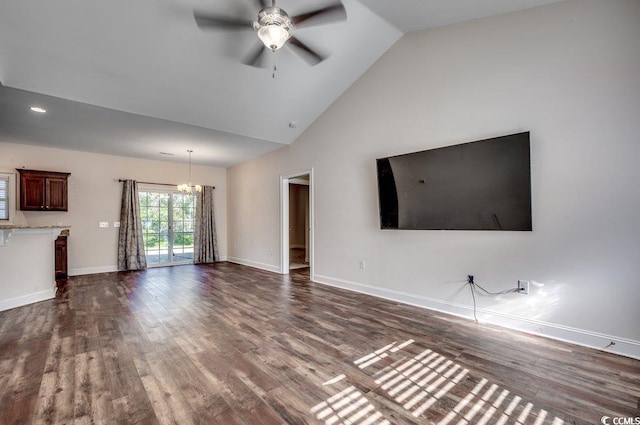 unfurnished living room featuring high vaulted ceiling, ceiling fan with notable chandelier, and dark hardwood / wood-style flooring