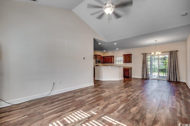 unfurnished living room with high vaulted ceiling, dark hardwood / wood-style flooring, and ceiling fan with notable chandelier