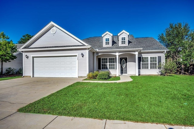 view of front of property with a garage and a front lawn