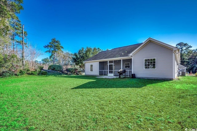 rear view of house with a yard, a patio, and central air condition unit