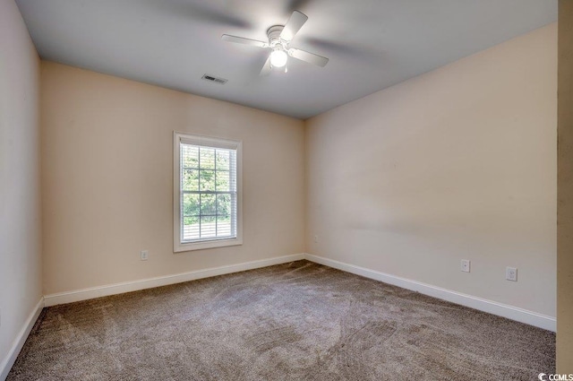 spare room featuring ceiling fan and carpet floors