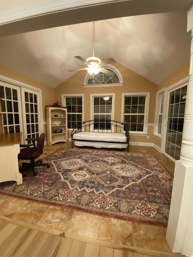 living area featuring hardwood / wood-style floors, ceiling fan, and vaulted ceiling