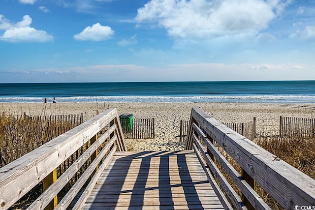 surrounding community featuring a view of the beach and a water view