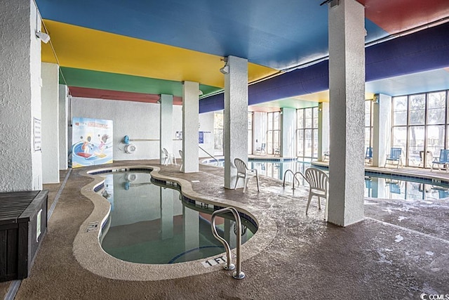 view of pool with an indoor hot tub