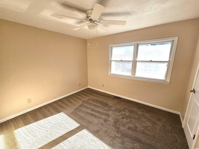 carpeted spare room with ceiling fan and a textured ceiling