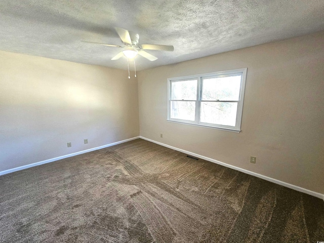 empty room with ceiling fan, carpet floors, and a textured ceiling