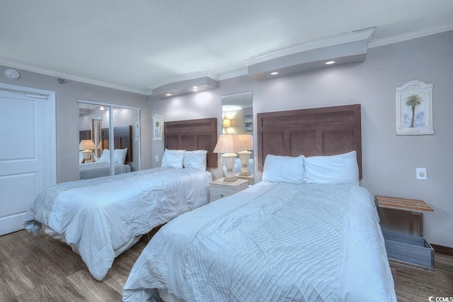 bedroom featuring crown molding, a closet, and dark hardwood / wood-style floors