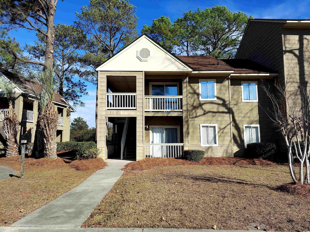 view of front of house with a balcony