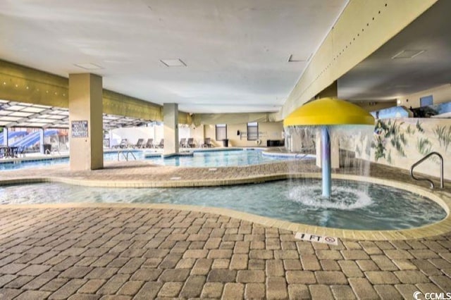 view of pool with an indoor hot tub