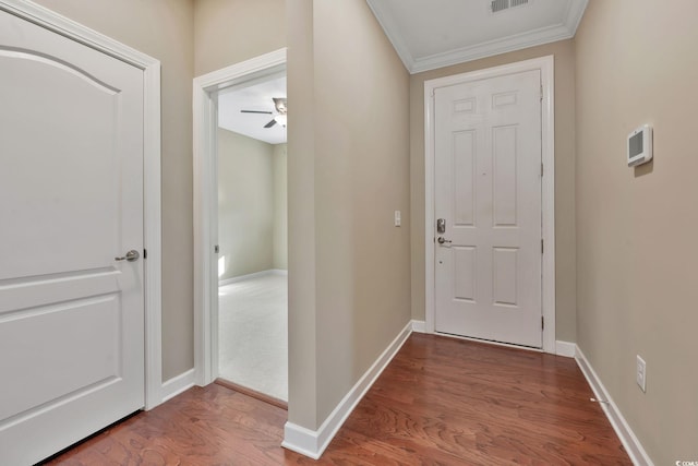 doorway to outside with ceiling fan, wood-type flooring, and ornamental molding