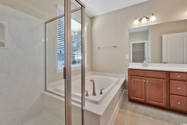 bathroom featuring tile patterned flooring, vanity, and separate shower and tub