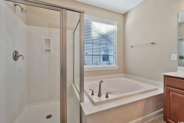 bathroom featuring vanity, shower with separate bathtub, and a wealth of natural light