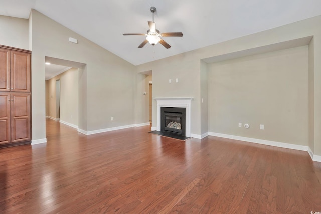 unfurnished living room featuring dark hardwood / wood-style flooring, vaulted ceiling, and ceiling fan