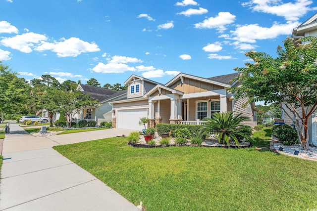 craftsman inspired home featuring a front yard, a porch, and a garage