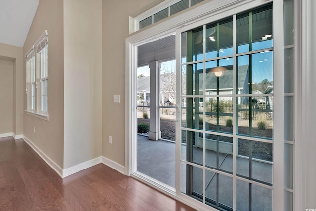 entryway with vaulted ceiling and dark hardwood / wood-style floors